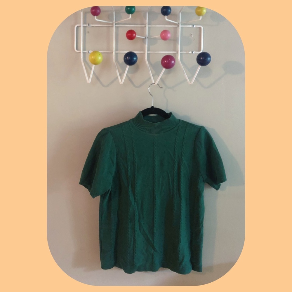 Short sleeved mock neck sweater.